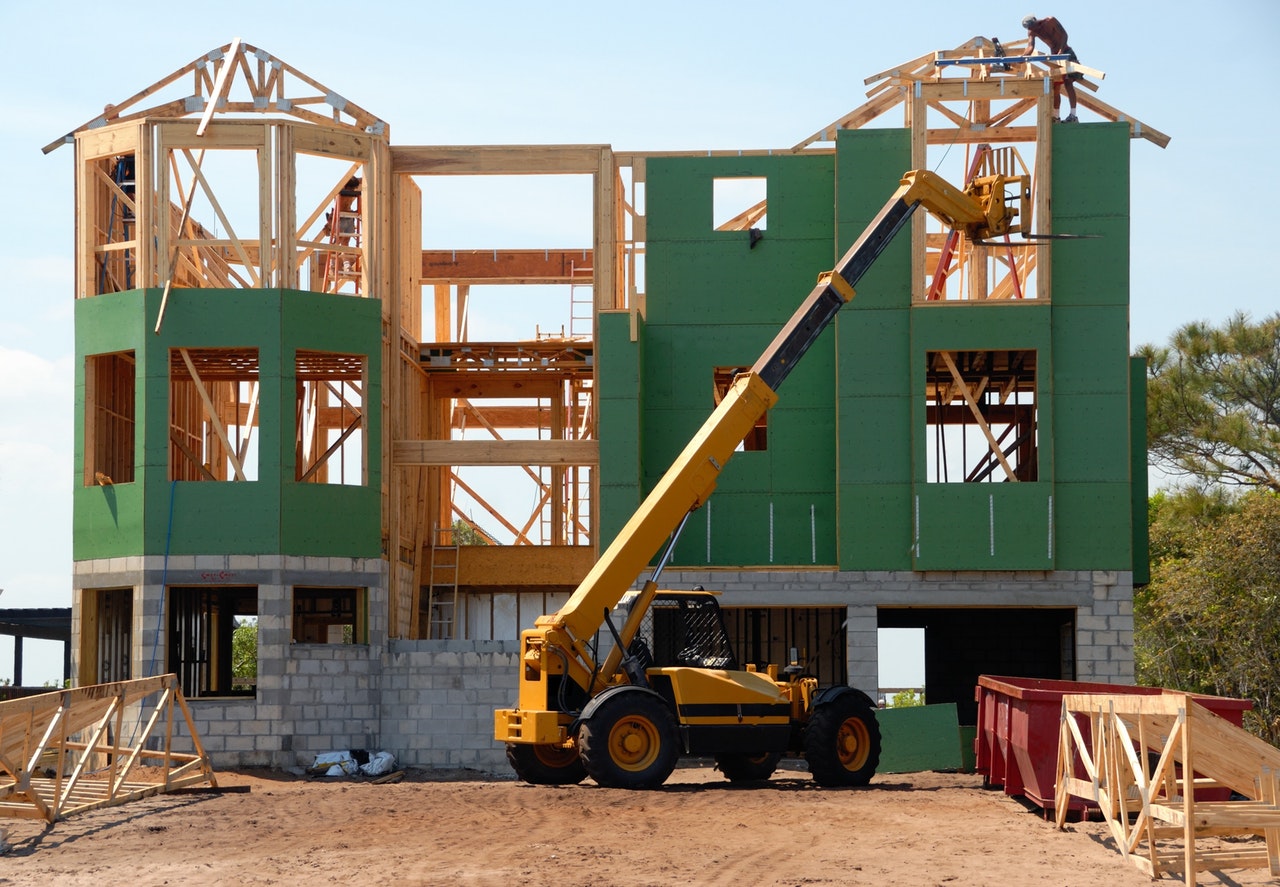 Residential property under construction with framing and lifting equipment, photographed for KAL Kreations